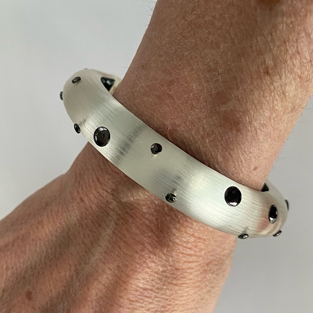 Alexis Bittar Frosted White Hinged Bangle Bracelet with metallic black dots